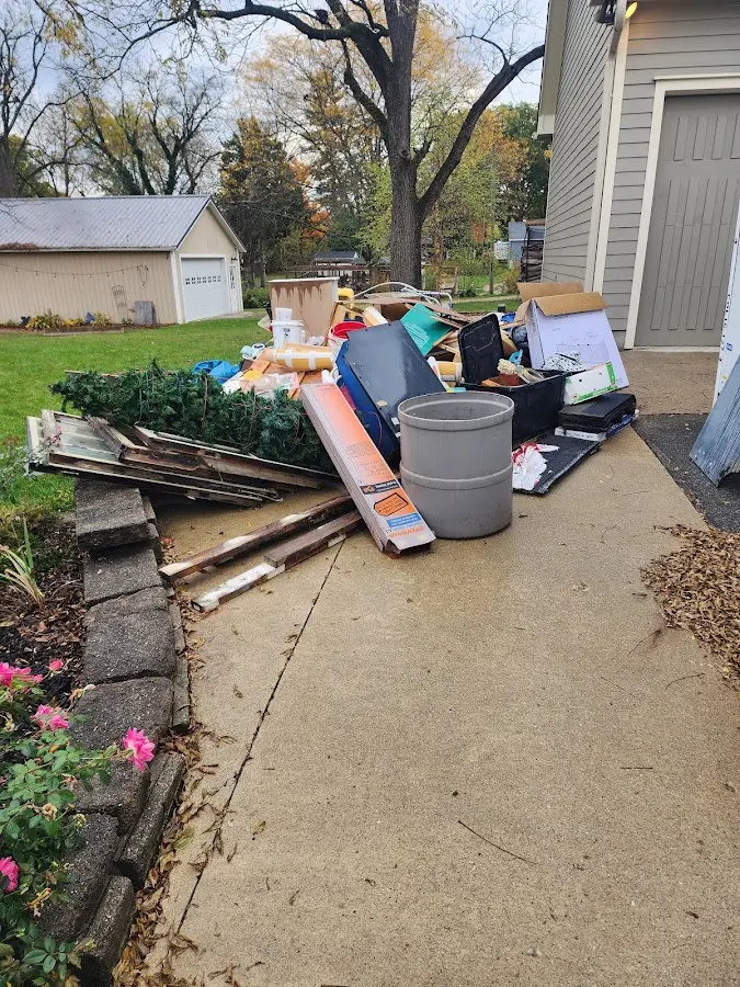 Dumpster being loaded with debris for Roofing Dumpster Rental in Raleigh Hills